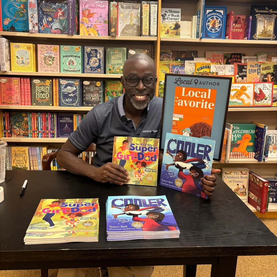 Tyson Bell at a bookstore signing with his books
